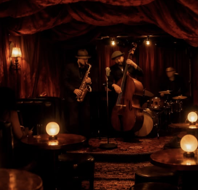 Jazz trio playing in a candlelit velvet lounge