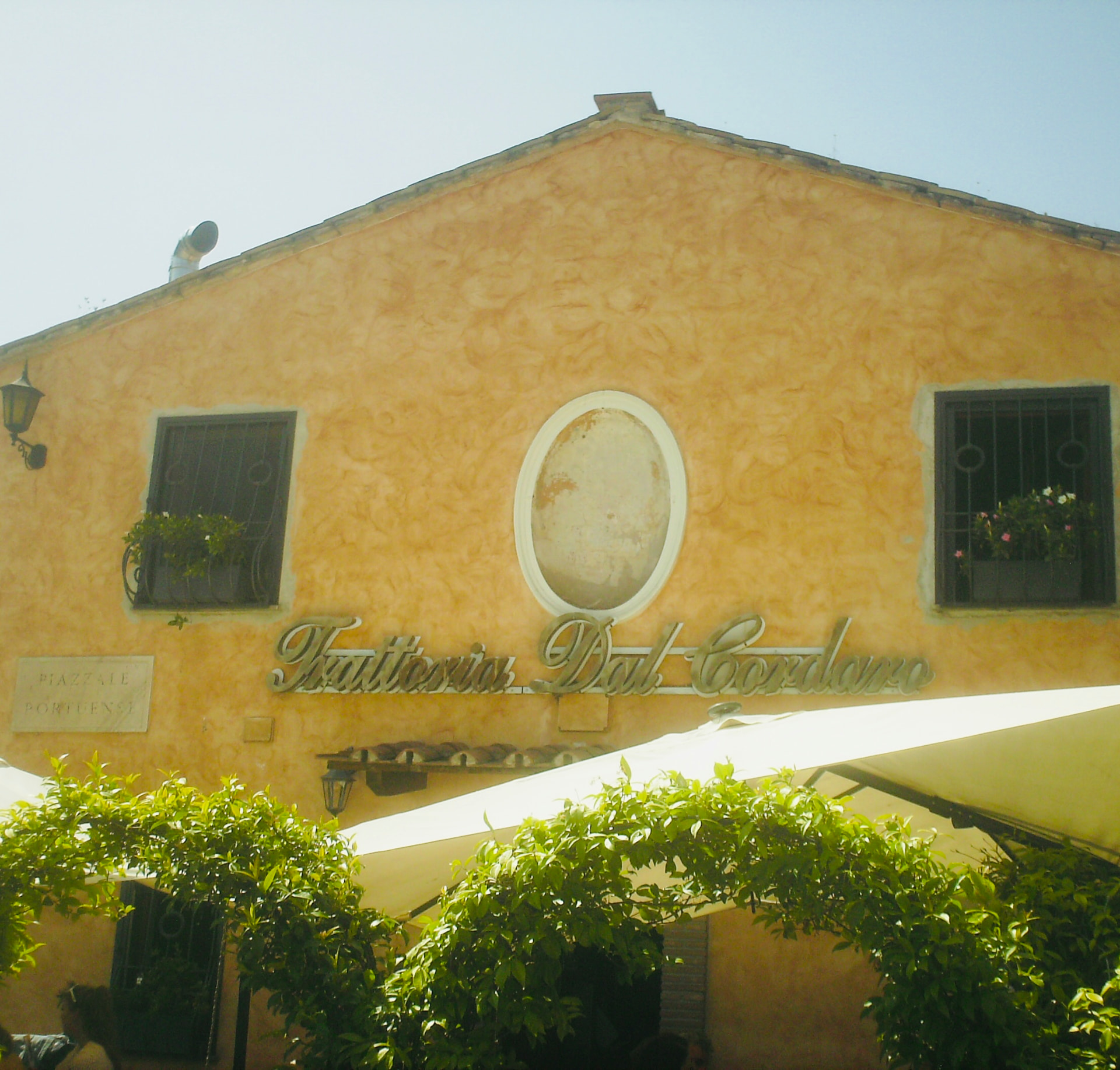 Trattoria Dal Cordonaro building facade in warm Italian sunlight