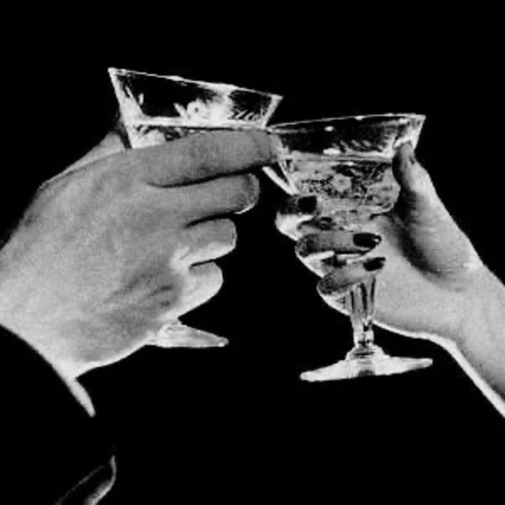 Vintage black and white photo of two coupe glasses toasting